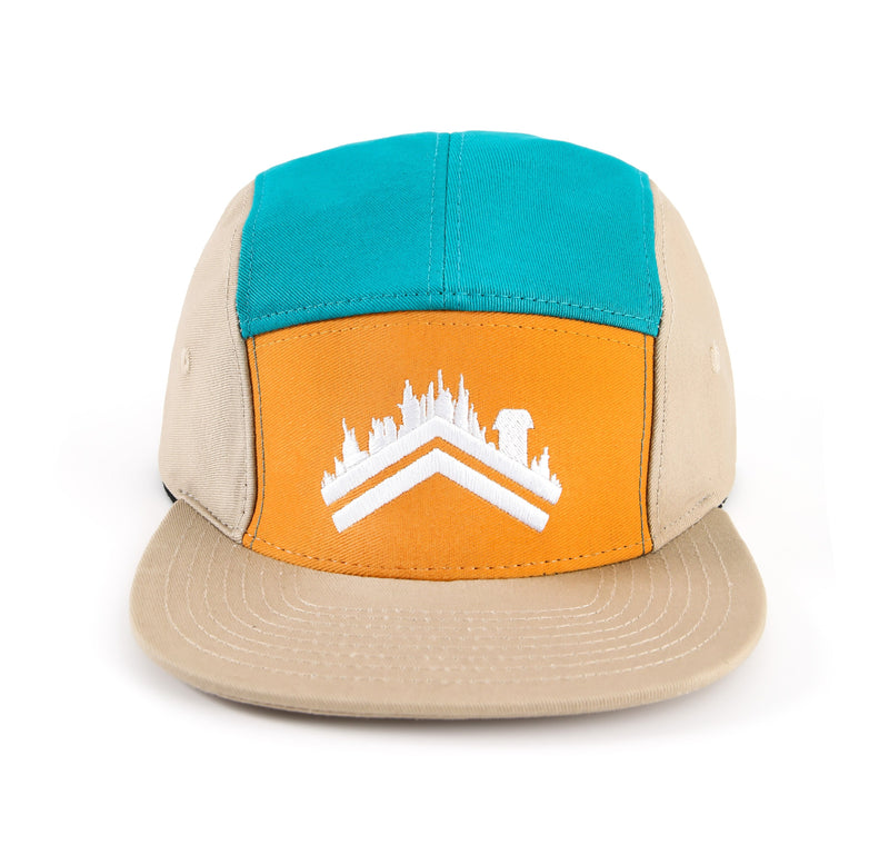 A forward facing deatil shot of the Friluft teal orange tan 5 panel cotton camper hat with the white aldri sur logo stitched on the front panel 